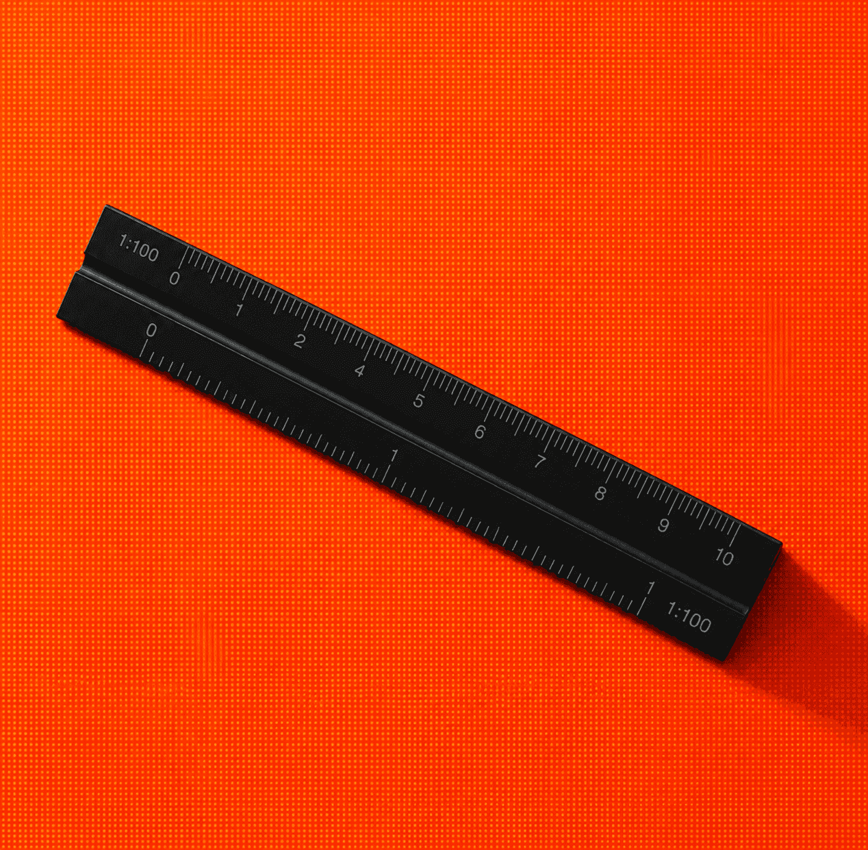 Black scale ruler on an orange textured surface